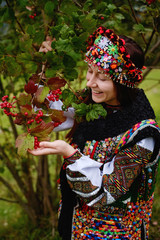 Beautiful brunette woman wearing traditional Hucul garment