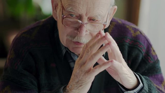 Closeup portrait of a very grumpy senior man. Who is arguing with someone
