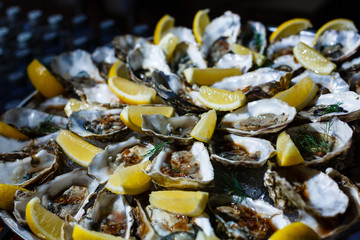 Paella dish with oysters with lemon wedges