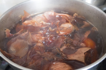 Onion husks cooked in a pot with water close-up