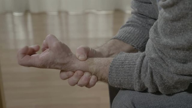 Closeup of aged old man hand affected by rheumatical ache