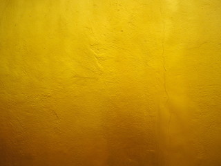 Golden wall on cement texture for background. Gold gradient.