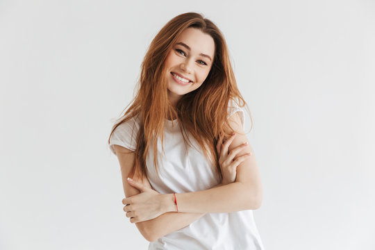 Happy woman in t-shirt posing with crossed arms