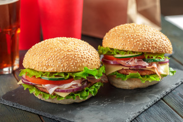 Fast food, homemade burger on a wooden background