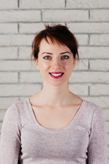 Portrait of attractive girl with smiling face mimic, showing exercise for face fitness