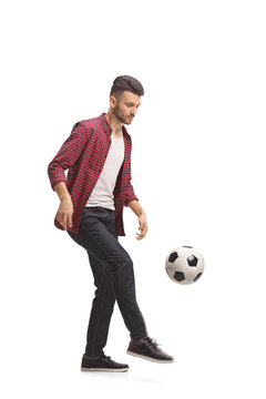 Young guy juggling a football