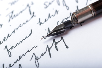 Fountain pen on an antique handwritten letter