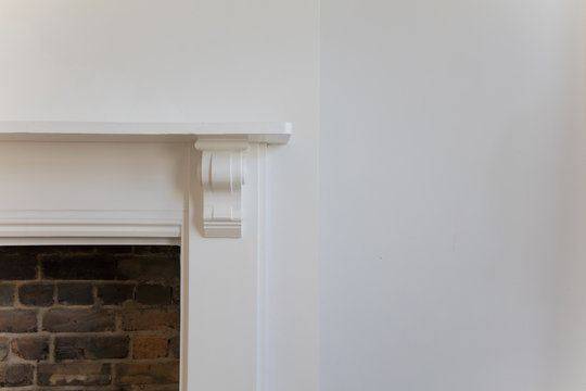 Victoriran Wooden Fireplace Surround With White Walls