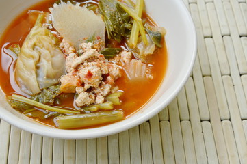 boiled mixed vegetable and fish egg in Thai spicy soup on bowl