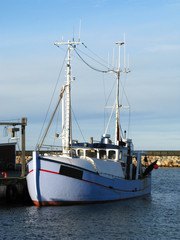Laesoe / Denmark: Fishing trawler at the quayside in Oesterby Havn on a sunny day in December © Torsten Grieger