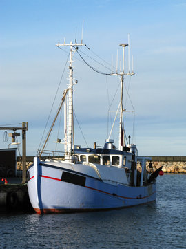 Laesoe / Denmark: Fishing trawler at the quayside in Oesterby Havn on a sunny day in December