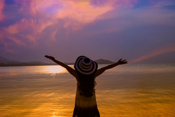 Silhouette Happy moment of woman Freedom and happiness on the beach which enjoy of nature during travel summer in holidays ,Freedom vacation concept