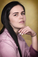 Portrait of beautiful young brunette woman isolated on Yellow  Background,  closeup.