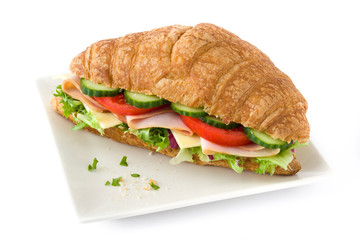 Croissant sandwich with cheese, ham and vegetables Isolated on white background