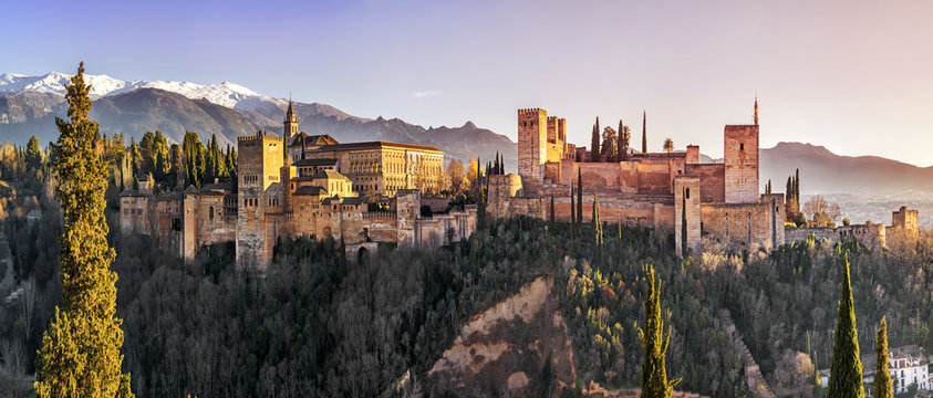 Palace and fortress complex Alhambra with Comares Tower, Palacios Nazaries and Palace of Charles V during sunset in Granada, Andalusia, Spain.