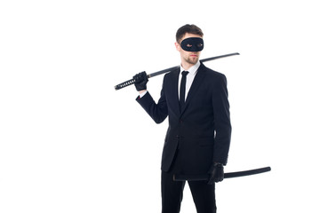 spy agent in mask and gloves with katana looking away isolated on white