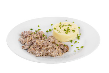Frikasse from beef, pork, lamb meat with side dish mash potato, Green onions on a plate isolated white background. Juicy fillet, roast. For the menu bar, restaurant, cafe Side view