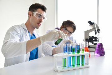 Two scientists are working in laboratory.