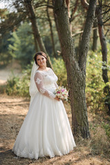 Obraz na płótnie Canvas Beautiful bride outdoors in a forest.