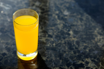 glass of orange juice on table in kitchen