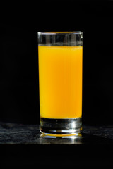 glass of orange juice on table in kitchen
