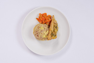 Tempeh with leek and mash on a white
