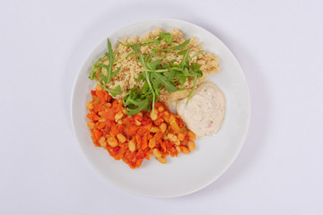 Baked beans and carrot with couscous on a white
