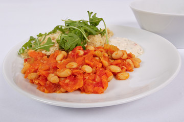 Baked beans and carrot with couscous on a white