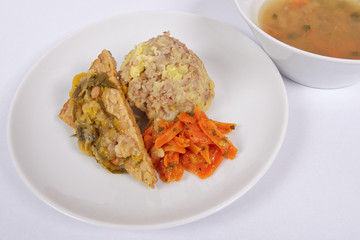 Tempeh with leek and mash on a white