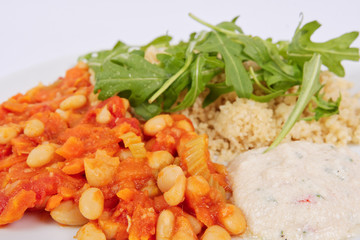 Baked beans and carrot with couscous on a white