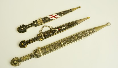 Daggers with ornate pattern on white background 