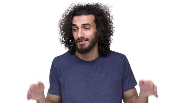 Portrait of unshaved hairy man shrugging and gesturing with both hands meaning oops sorry have no idea, over white background. Concept of emotions