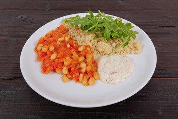 Baked beans and carrot with couscous on a table