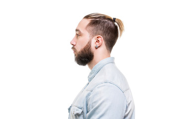 Closeup side view portrait of bearded stylish man dressed in shirt isolated at white background.