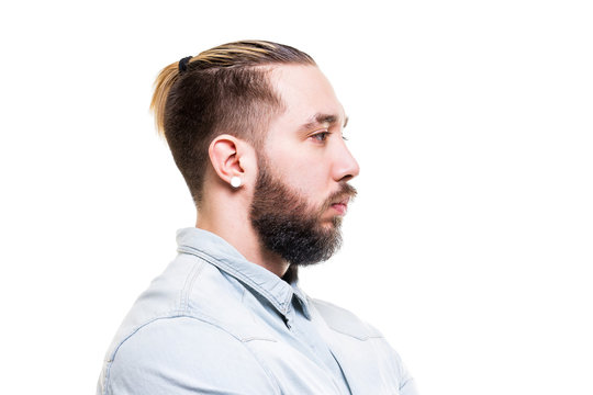 Closeup portrait of young bearded serious caucasian man in shirt isolated at white background.