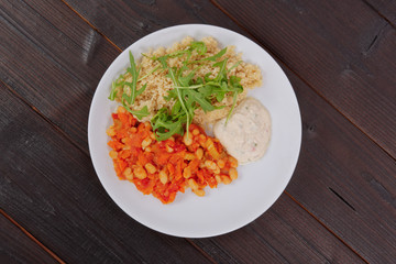 Baked beans and carrot with couscous on a table