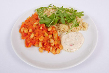 Baked beans and carrot with couscous on a white