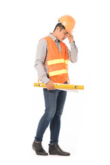Studio portrait of construction worker in orange waistcoat and hardhat holding levelling tool and building plan