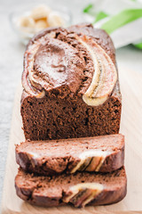 Cocoa buckwheat banana bread on light concrete background. Selective focus, space for text.