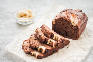 Cinnamon banana bread on light concrete background. Selective focus, space for text.