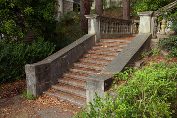 beautiful original staircase made of stone in a green summer park
