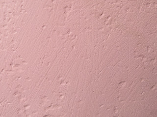 Pink stucco wall texture background. Old painted rough wall, peach color 