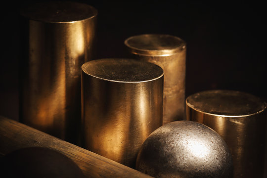 Metal parts of cylindrical and spherical shape on a black background. Non-ferrous metal. 