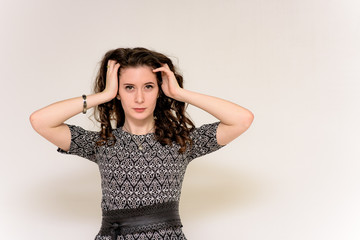 Fototapeta premium beautiful young brunette girl on a white background in different poses