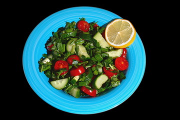 Tomatoes and cucumber salad on a blue plate with no background. Isolated.
