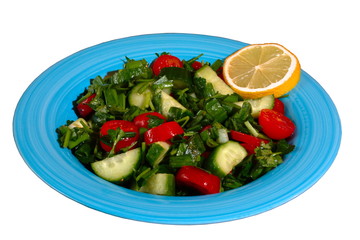 Tomatoes & cucumber fresh salad on a blue plate, on the white background. 