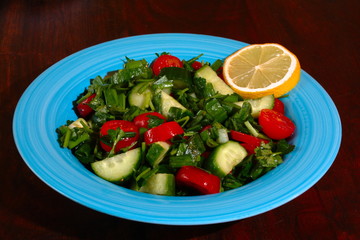 Fresh cucumber & tomatoes salad on the wooden table. Isolated.