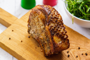 Fried piece of pork on a cutting board side view