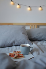Fototapeta na wymiar Breakfast in bed. Cup of tea and white chocolate