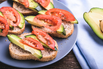 Toast with avocado and tomato slices